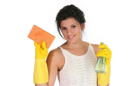 Professional cleaning team in office kitchen